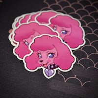 a group of pink poodle stickers on a black surface