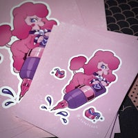 a stack of pink stickers with a pink poodle on them